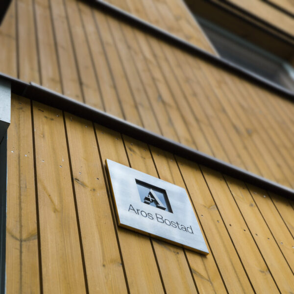 Fastighetsskylt i borstat och polerat rostfritt stål med graverad färgfylld och dekaperad logotyp och text