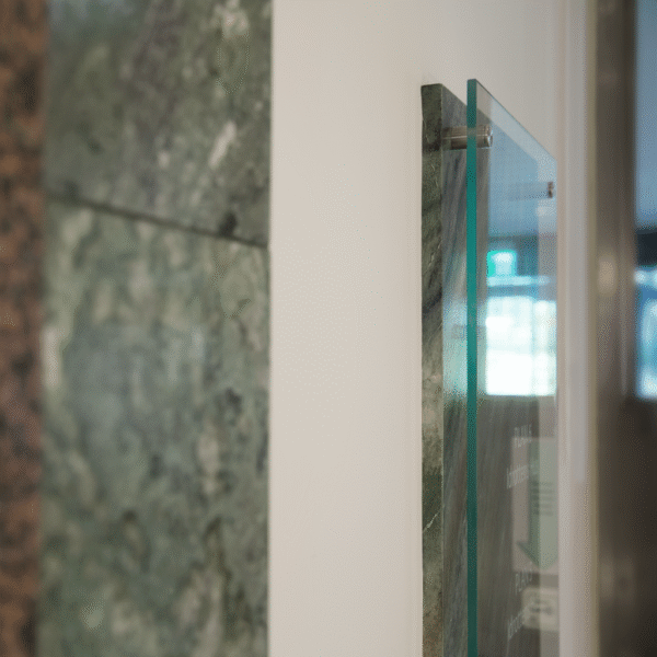 Newsec Folksam fastighetsregister – distansmonterad glasskylt i härdat planglas med vinyldekor mot marmorerad bottenplatta - Bild 2