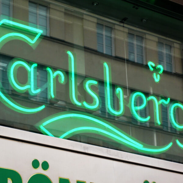 Fasadskylt i grön lackerad aluminium med förhöjd sarg, skärmningskant och grön LED-neon – monterad på insidan av fasadfönster - Bild 5