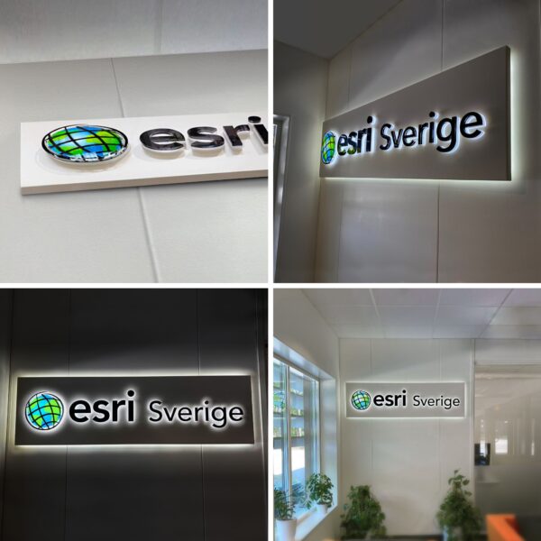 Receptionsskylt med vit bakgrundsplatta och LED-bakbelysning, svarta profilbokstäver i lackerat rostfritt stål samt dubbelbelyst logotyp med digitaltryckt dekor och akryltopp - Bild 6