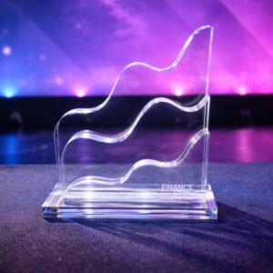Clear acrylic award with three flowing wave shapes on a base, inscribed with 'FINANCE ARENA AWARDS' against a purple backdrop.